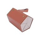 Brown leather pouch with gold studs on a white background