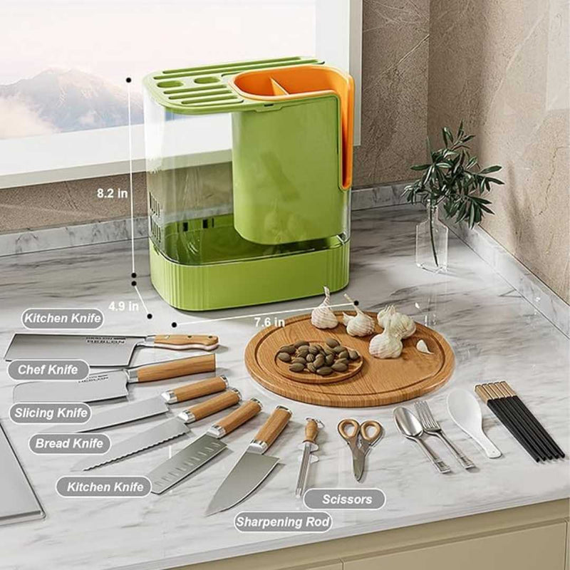 Green kitchen organizer with various knives, a cutting board, and utensils on a marble countertop.