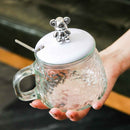Clear glass cup with bear-shaped lid and hammered design for tea or coffee – cupindy