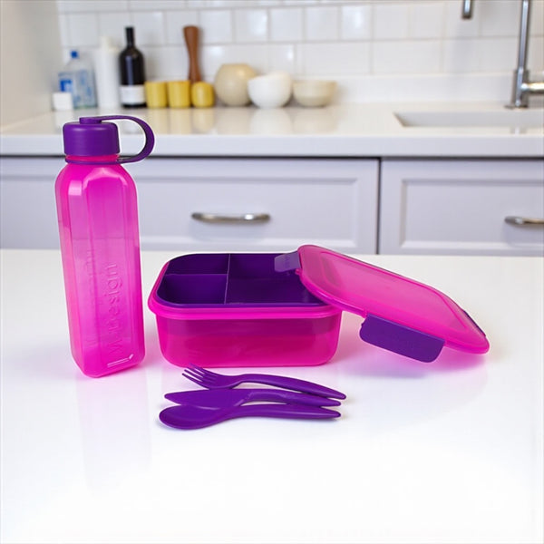 Pink and purple lunch box set with bottle and utensils on a kitchen counter