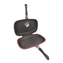 Double-sided grill pan with black interior and red exterior on a white background