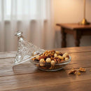 Glass bowl with assorted nuts on a wooden table