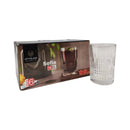 Clear glass tumbler next to its packaging on a white background