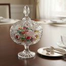 Decorative glass candy dish with colorful interior on a table.