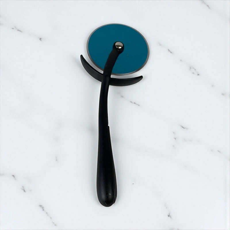 Black pizza cutter with blue wheel on a marble surface