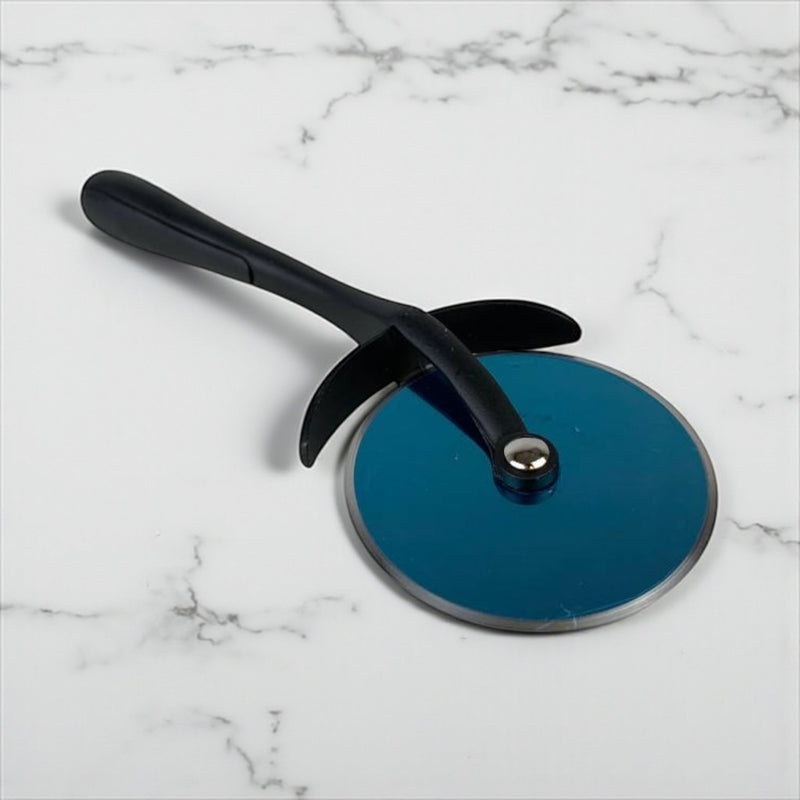 Blue pizza cutter with black handle on a marble surface