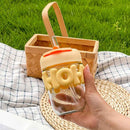 Colorful glass drinking cup with silicone grip and reusable straw