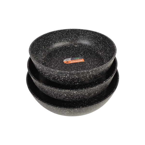 Set of three black speckled bowls stacked on a white background