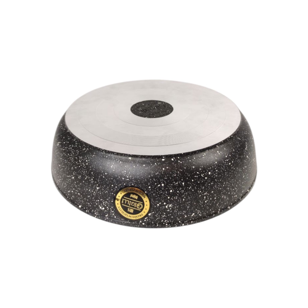 Round black and white ceramic dish with a gold label on a white background