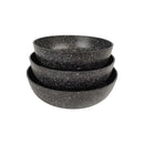 Set of three black speckled bowls stacked on a white background