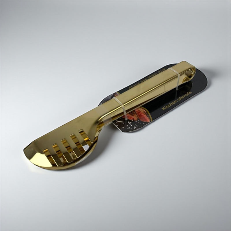 Gold-colored kitchen tool on a gray background