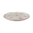Ceramic plate with pink floral design on a white background