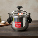 Stainless steel pressure cooker with Magefesa label on a wooden surface