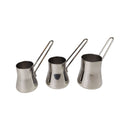 Three stainless steel jiggers on a white background