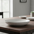 White ceramic bowl with black rim on a wooden table