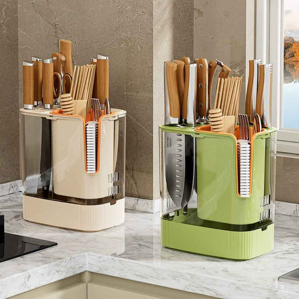 Two kitchen utensil holders, one beige and one green, on a kitchen counter.