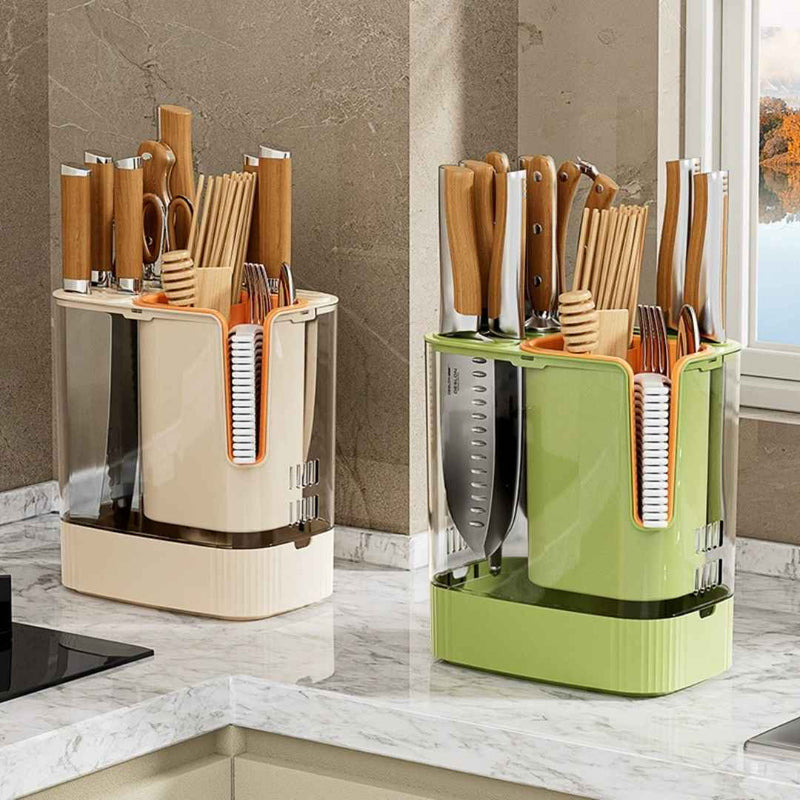 Two kitchen utensil holders, one beige and one green, on a kitchen counter.