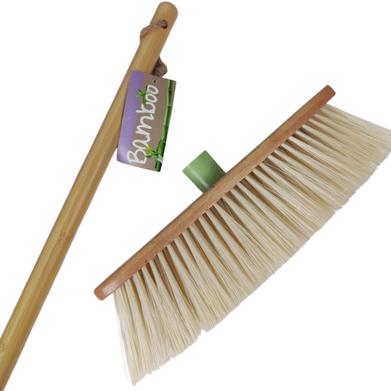 Bamboo broom with a green handle on a white background