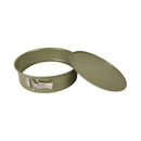 Green metal cake tin with a lid on a white background