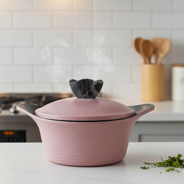 Pink ceramic pot with a lid on a kitchen counter