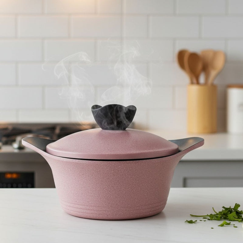 Pink ceramic pot with a lid on a kitchen counter