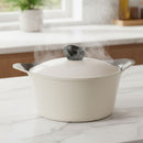 White ceramic pot with steam rising on a marble countertop