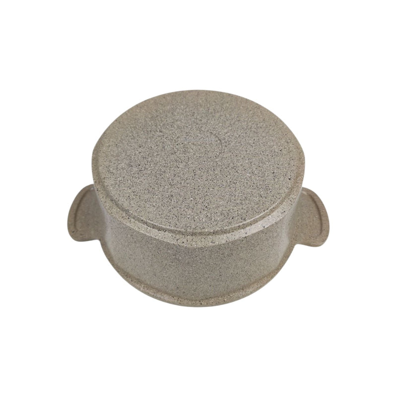 Round stone-like object with a textured surface on a white background