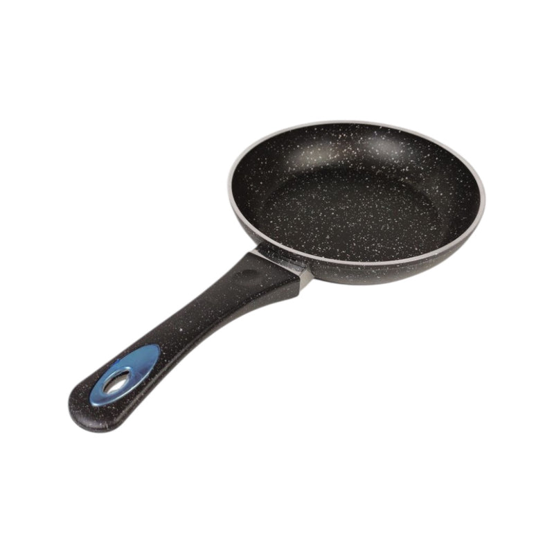 Black frying pan with speckled pattern on a white background