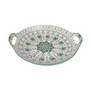 Decorative ceramic bowl with green and white pattern on a white background
