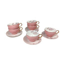 Set of pink teacups and saucers with floral patterns on a white background