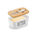 Butter dish with wooden lid and knife on a white background