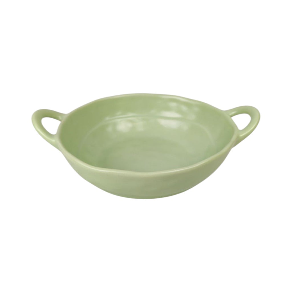 Green ceramic bowl with handles on a white background