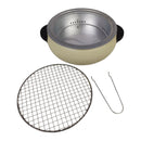 Portable stove with a mesh grate and tong on a white background