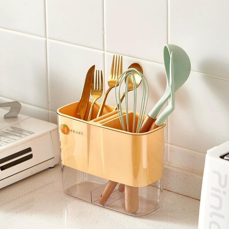 Kitchen utensil holder with utensils on a tiled kitchen counter