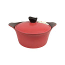 Red casserole dish with black handles on a white background