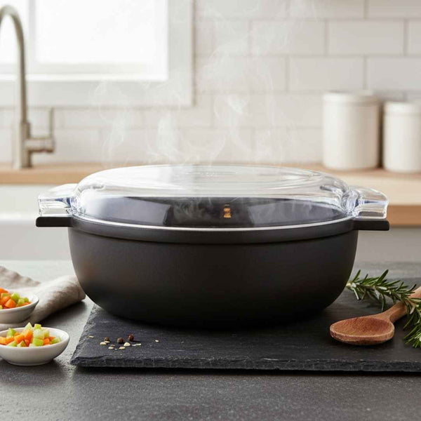 Black cookware set with glass lid on a kitchen counter