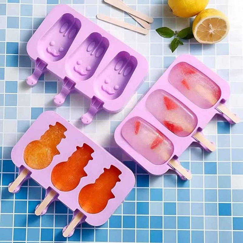 Purple silicone ice pop molds with shaped cavities on a blue tiled background.