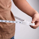 Fitness trainer using body tape to check arm circumference