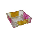 Square transparent glass ashtray with ribbed yellow and pink edges, modern decorative smoking accessory