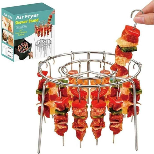 Air fryer skewer stand with skewers of vegetables and a packaging box in the background.