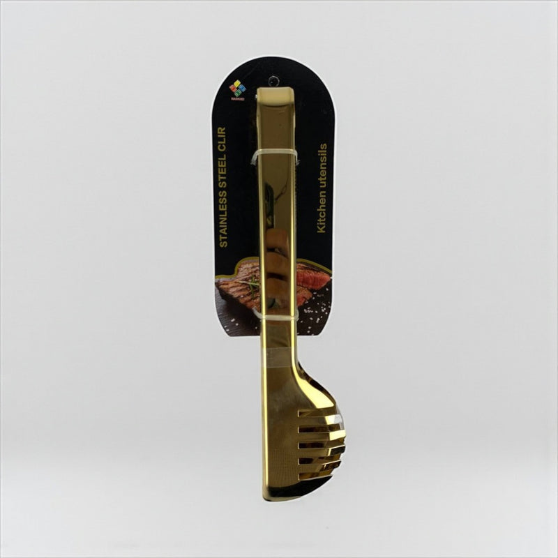 Gold kitchen utensil set with packaging on a light gray background