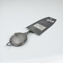 Metallic tea strainer with a tag on a light gray background