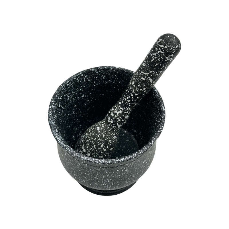 Top view of black speckled granite-style mortar and pestle for grinding herbs, spices, and seeds in the kitchen