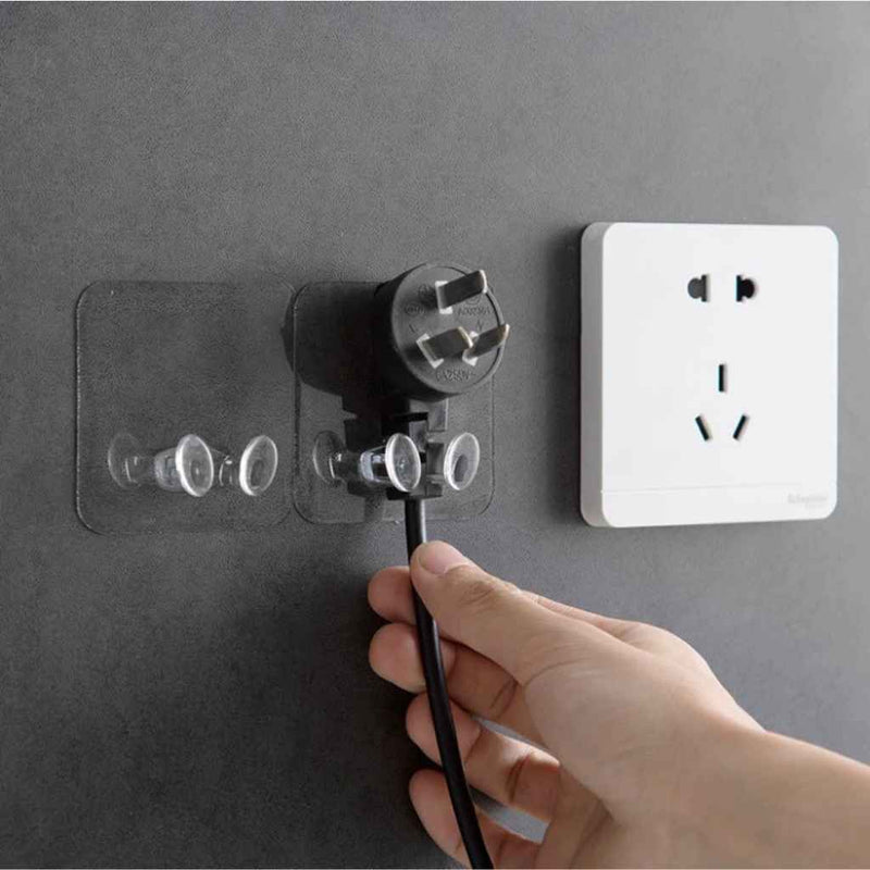 Transparent wall plug holder with adhesive backing, easy to mount on tile, glass, or metal | Cupindy