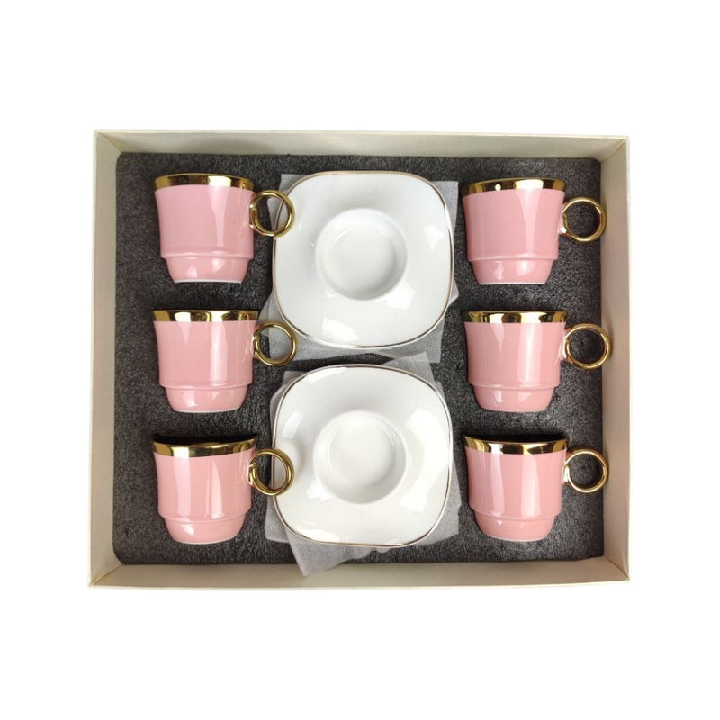 Set of pink ceramic cups with gold rims in a box
