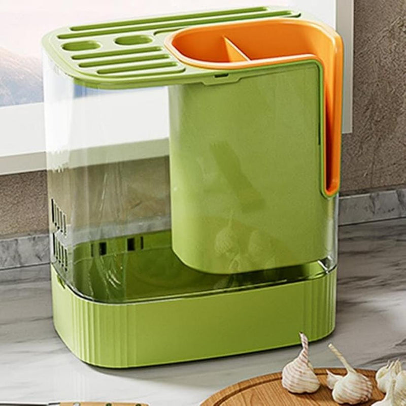 Green and orange kitchen storage bin with garlic on a wooden cutting board.
