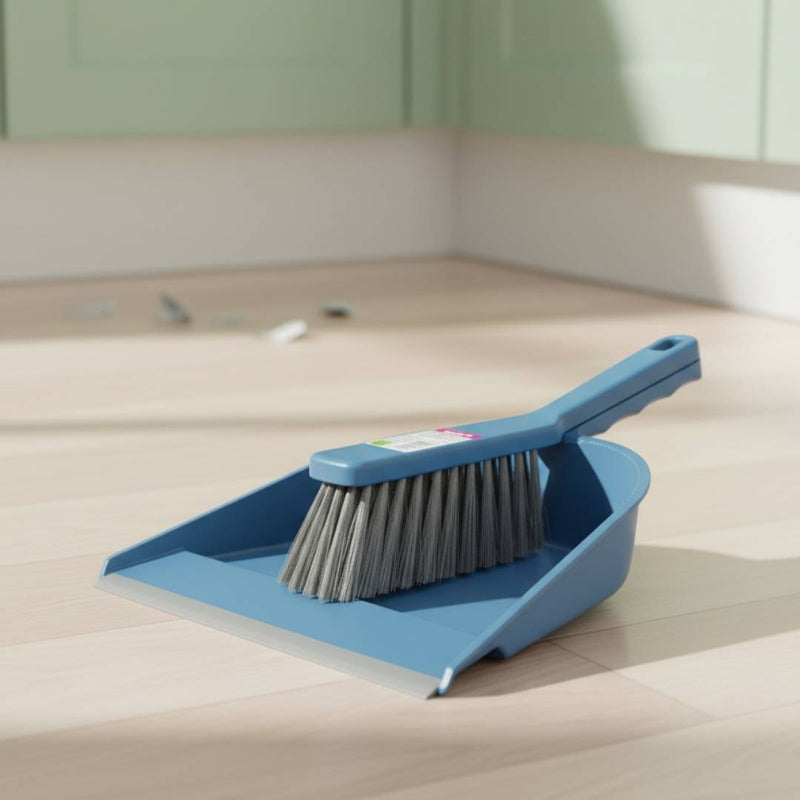 Blue dustpan and brush set on a wooden floor
