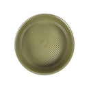Green round baking dish with textured surface on a white background
