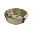 Green cake pan with a Zojirushi branded baking paper on a white background